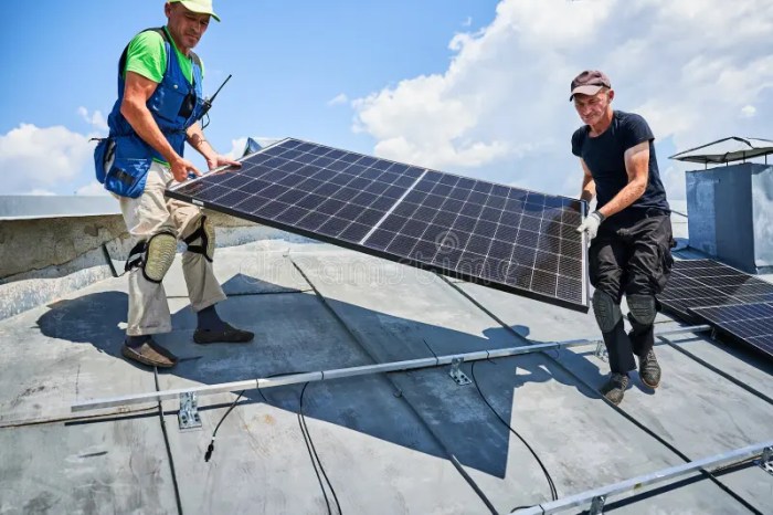Workers Building Solar Panel System on Roof of House. Installers ...